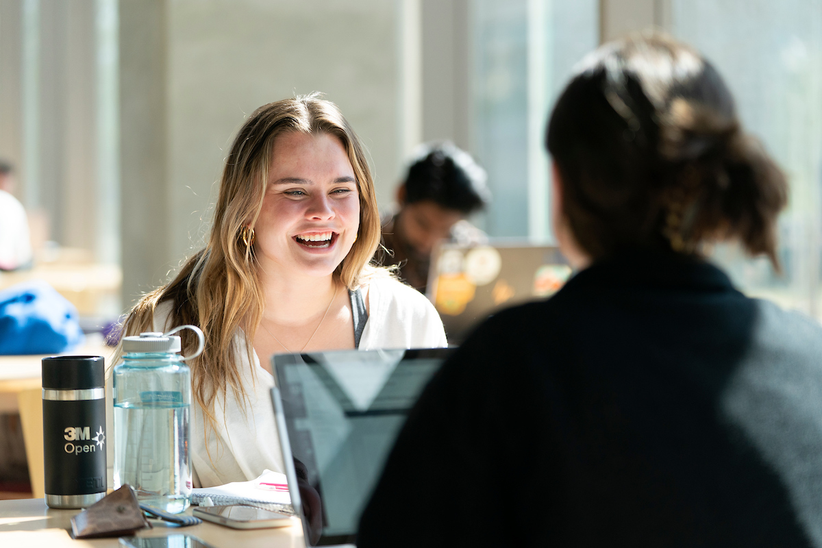 A student smiles while getting mentored in the Zachry Engineering Education Complex.